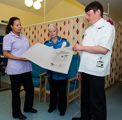 St Cross staff discussing how the new monitors will be used.